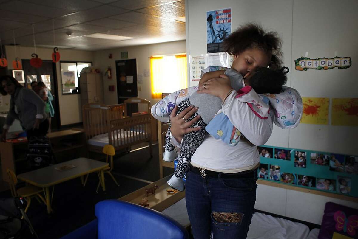 Brijjanna Price wakes her daughter LaMya up from her nap at daycare, Wednesday, October 23, 2013, in Oakland, Calif. Brijjanna attended the California School-Age Families Education (Cal-SAFE)  program when she discovered she was pregnant soon after her brother was killed and continued after giving birth. Photo: Lacy Atkins, The Chronicle