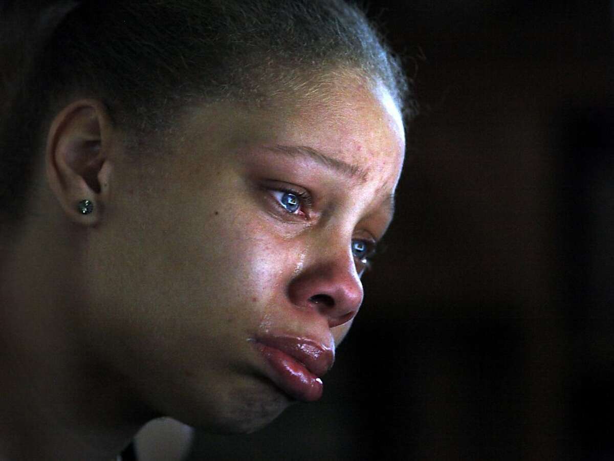 Brijjanna Price, 16, cries as she looks at a picture of her brother Lamont DeShawn Price, 17, on the computer screen, just two months after he was killed in Oakland, Calif. " I just wanted to see and remember his eyes," she said.  Lamont  was one of the 131 homicide victims of 2012. Photo: Lacy Atkins, The Chronicle
