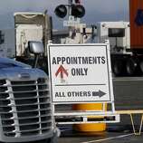 A sign on the busy Middle Harbor Road trying to direct truckers to terminals Wednesday December 17, 2014. Truck drivers at the Port of Oakland often face long waits to get inside the terminals and pick up containers in a timely manner.