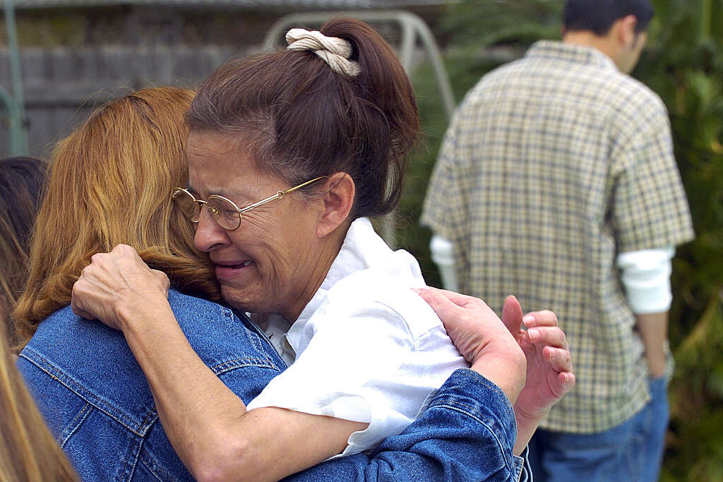 Juanita Ramos, widow of victim Art Ramos, embraces Margaret Jasso three days after the explosion.