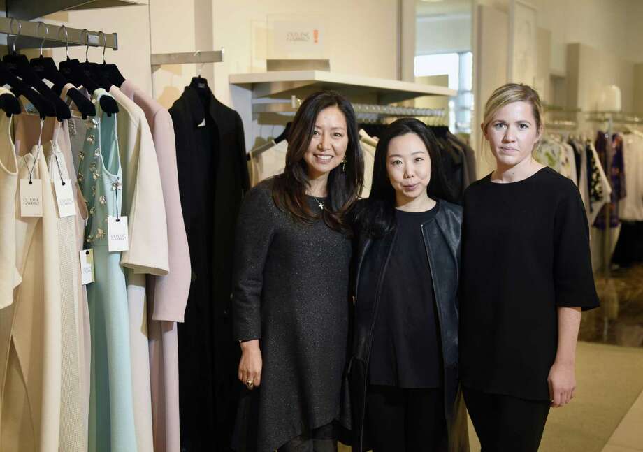Olivine Gabbro President Sue Neumann, left, Designer and Creative Director Grace Kang, center, and Asst. Creative Director Gracie Wills pose by the Olivine Gabbro clothing line displayed at Richards in Greenwich, Conn. Thursday, Feb. 23, 2017. The Greenwich-based women's fashion design brand, which has been featured in several New York Fashion Weeks and worn by stars attending the Oscars, formally launched its new partnership with Richards Thursday. Photo: Tyler Sizemore / Hearst Connecticut Media / Greenwich Time