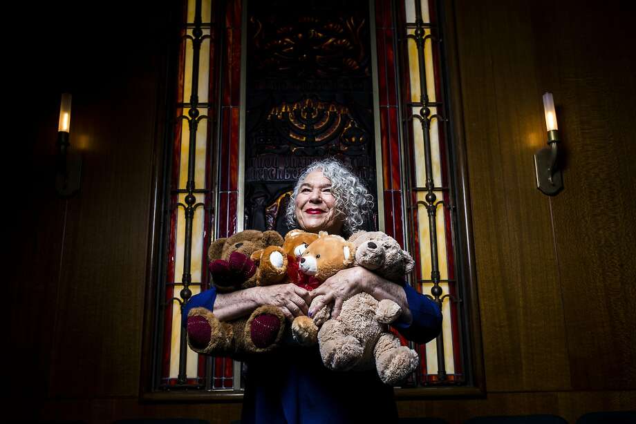 Samantha Grier, founder and president of Caring for Children, a nonprofit that has sent therapeutic tools to emotionally deprived children since 1986, holds teddy bears at Congregation Emanu-El’s temple in San Francisco. Photo: Stephen Lam