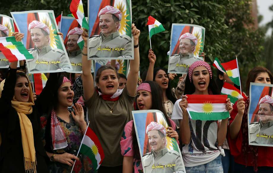 Students at Salahaddin University in Irbil, Iraq, hold posters showing their support for Kurdish leader Masoud Barzani. Barzani has decided to step down and not seek re-election. Photo: SAFIN HAMED, AFP/Getty Images