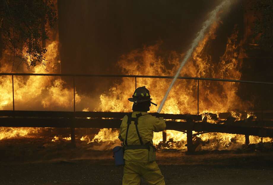 A firefighter sprays a hose into a Keysight Technologies building in Santa Rosa. More than 100 boxes containing letters and other documents from Hewlett-Packard founders William Hewlett and David Packard were incinerated when the Tubbs fire tore through one building on Keysight’s campus. Photo: Jeff Chiu, Associated Press