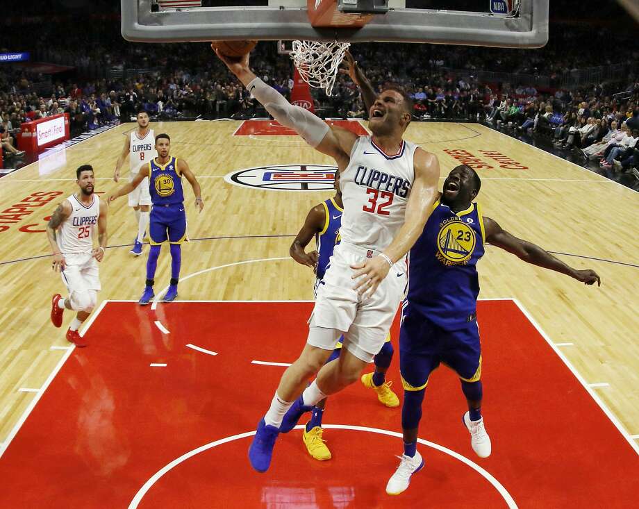 Los Angeles Clippers forward Blake Griffin, center, goes to the basket while being defended by Golden State Warriors forward Draymond Green, right, during the first half of an NBA basketball game, Monday, Oct. 30, 2017, in Los Angeles. (AP Photo/Ryan Kang) Photo: Ryan Kang, Associated Press
